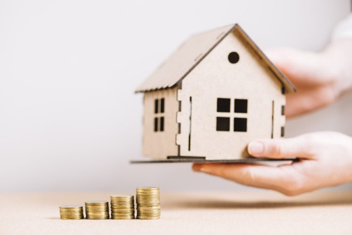 crop-hand-holding-house-near-coins (2)