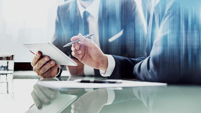 corporate-businessmen-working-tablet-office Bagaimana Strategi Marketing Law Firm yang Efektif