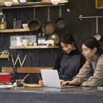 japanese-man-woman-working-using-laptop-restaurant